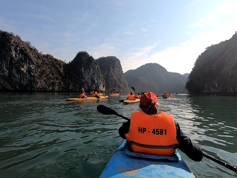 Kayaking through the limestone islands of Ha Long Bay, Vietnam.