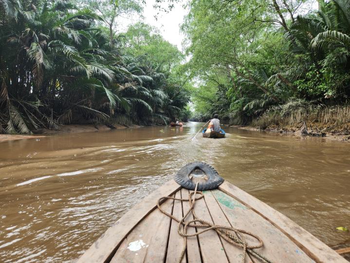 Using sampans to navigate past Con Quy island.