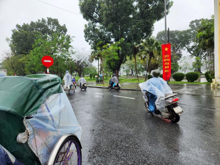The limited view from a raincoat covered cyclo in Hue.